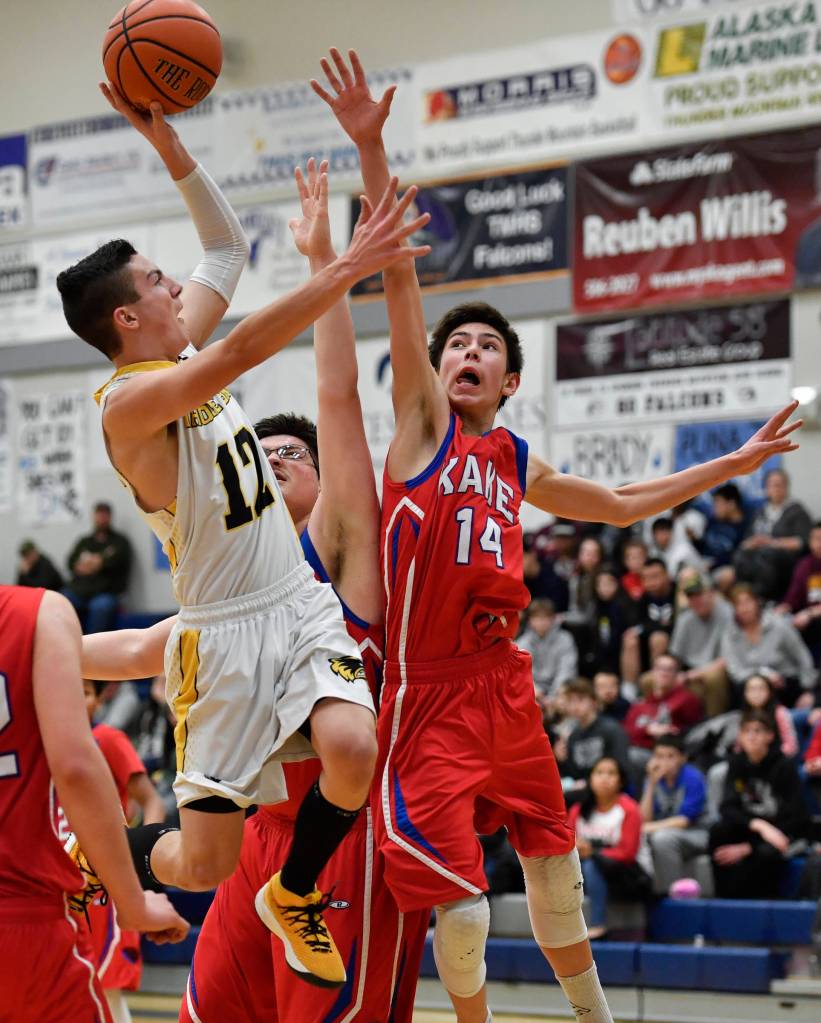 Thorne Bays Stockton Schwab, left, shoots against Kakes Luke Hanson, center, and Shawn Merry in the final of the Region V 1A Basketball Championships at Thunder Mountain High School on Friday, March 1, 2019. Thorne Bay won 55-44. (Michael Penn | Juneau Empire)