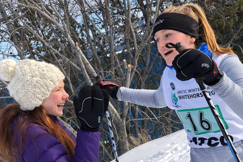 Juneau Nordic Ski Teams Annika Schwartz, left, congratulates teammate Lindsay McTague after she finishes the second and final leg of the Yukon Ski Marathon in Whitehorse, Yukon, on Saturday, March 2, 2019. Schwartz and McTague, racing as Chix on Stix, came in fourth place in the female 50 kilometer relay. (Courtesy Photo | Gretchen Harrington)