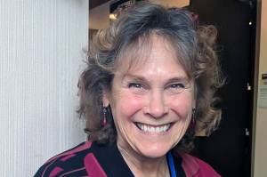 Author Annie Boochever, formerly of Juneau and now of Bellingham, Washington, smiles at Centennial Hall, Saturday March 2, 2019. (Ben Hohenstatt | Capital City Weekly)