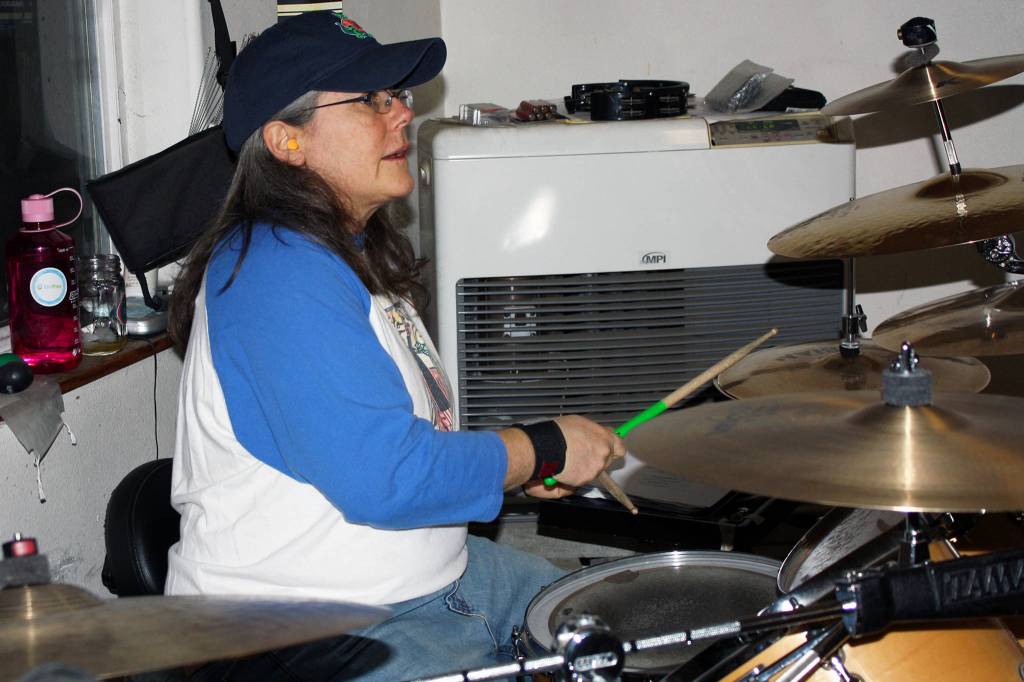 Kelly Henriksen plays drums during a Fire on McGinnis practice Saturday, March 9, 2019. (Ben Hohenstatt | Capital City Weekly)