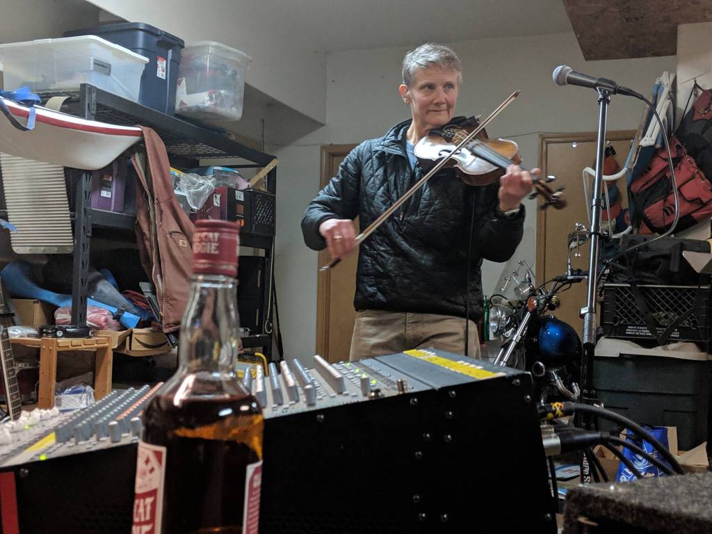 Martha DeFreest plays fiddle during a Fire on McGinnis practice Saturday, March 9, 2019. (Ben Hohenstatt | Capital City Weekly)
