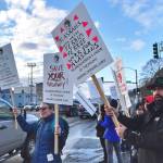 Sarah Eppon, left, and Earling Walli, right, join other ferry workers with the Inlandboatmens Union of the Pacific as they rally for support at 10th Street and Egan Drive on Friday, March 8, 2019. (Michael Penn | Juneau Empire)