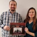 Carrie Amott, a board member of the Great Bear Recovery Collective, and Mike VanLinden, re-entry case manager for Great Bear Recovery Collective, hold up a poster for their organizations upcoming movie night. (Courtesy Photo | Great Bear Recovery Collective)