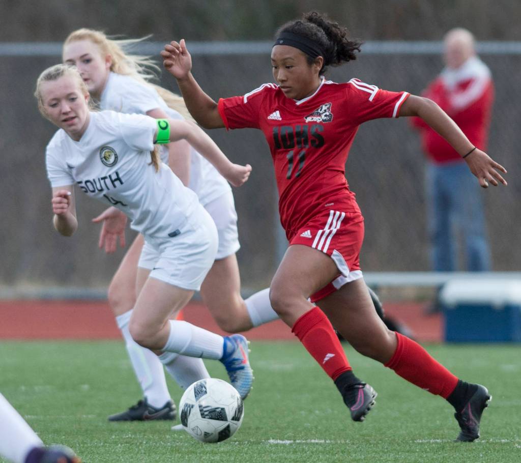 Juneau-Douglas Malia Miller, right, drives against Souths Natalia Cole at Thunder Mountain High School on Friday, April 21, 2017. (Michael Penn | Juneau Empire File)