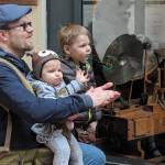 Andy Mills and his children, 1-year-old Eden, and 3-year-old Malcolm, applaud during a Kimball pipe organ concert, Friday, March 15, 2019. (Ben Hohenstatt | Capital City Weekly)
