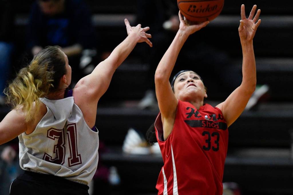 Hoonahs Krissy Bean shoots over Haines Rachel Brittenham in the womens bracket game at the Gold Medal Basketball Tournament on Thursday, March 21, 2019. (Michael Penn | Juneau Empire)