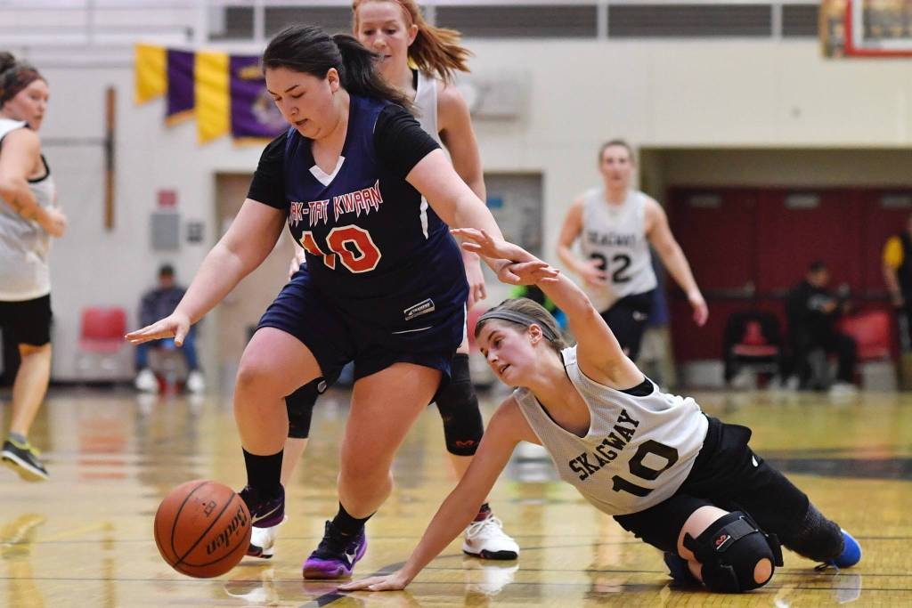 Yakutats Nadine Fraker, left, dribbles away from Skagways Kaylie Smith during their womens bracket game at the Lions Clubs Gold Medal Basketball Tournament on Thursday, March 21, 2019. (Michael Penn | Juneau Empire)