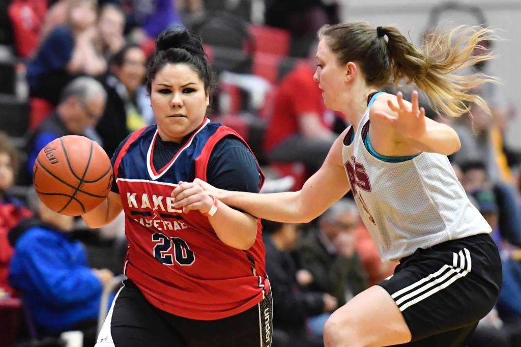 Kakes Monica Ashenfelter, left, drives against Haines Rachel Brittenham at the Juneau Lions Club Gold Medal Basketball Tournament at JDHS on Wednesday, March 20, 2019. (Michael Penn | Juneau Empire)