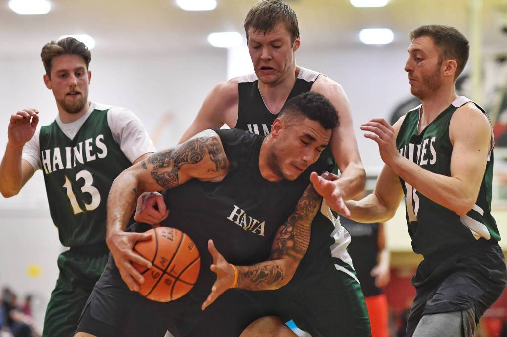 Hydaburgs Damen Bell-Holter, center is surrounded by Haines players in their B bracket game at the Lions Club Gold Medal Basketball Tournament on Thursday, March 21, 2019. (Michael Penn | Juneau Empire)