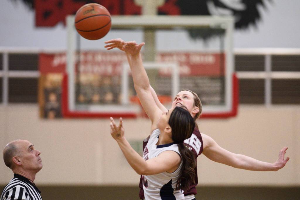 Haines Liz Segars, back, and Yakutat s Lorena Williams tip off at the Gold Medal Basketball Tournament on Friday, March 22, 2019. (Michael Penn | Juneau Empire)