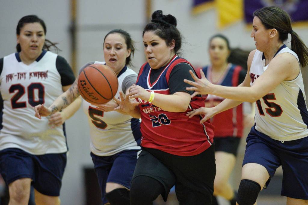 Kakes Monica Ashenfelter is chased by Yakutats Kim Buller, left, and Lorena Williams, right, in the womens bracket game at the Juneau Lions Club Gold Medal Basketball Tournament at JDHS on Tuesday, March 19, 2019. (Michael Penn | Juneau Empire)