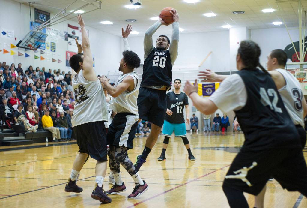 Metlakatas Willie Hayward shoots over several Angoon players in their B bracket game at the Lions Club Gold Medal Basketball Tournament on Thursday, March 21, 2019. (Nolin Ainsworth | Juneau Empire)