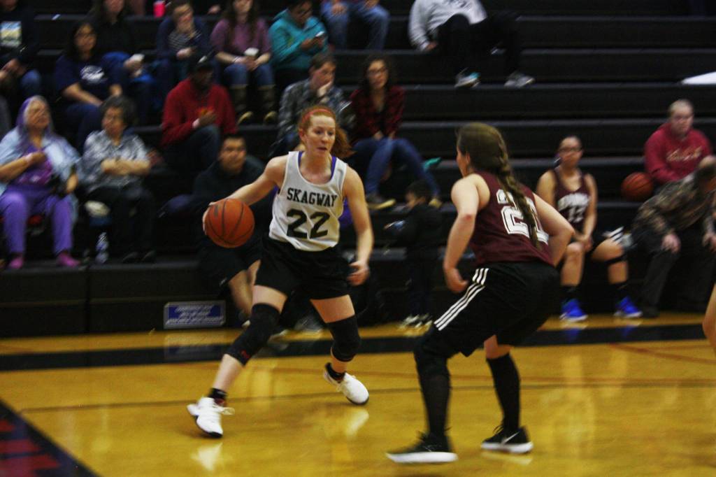 Jesse Ellis puts a move on her defender during the Gold Medal Basketball Tournament Monday. (Ben Hohenstatt | Juneau Empire)