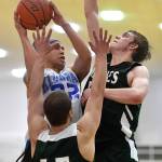 Klukwans Terrance Wheat is blocked from shooting by Haines Dylon Swinton, right, and Brian Combs in a B bracket game at the Juneau Lions Club 73rd Annual Gold Medal Basketball Tournament at Juneau-Douglas High School: Yadaa.at Kalé on Tuesday, March 19, 2019. Haines won 97-51. (Michael Penn | Juneau Empire)