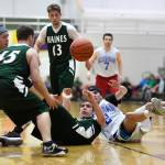 Haines Dylon Swinton, center, passes the ball up to his teammate Brian Combs in a B bracket game at the Juneau Lions Club 73rd Annual Gold Medal Basketball Tournament at Juneau-Douglas High School: Yadaa.at Kalé on Tuesday, March 19, 2019. Haines won 97-51. (Michael Penn | Juneau Empire)