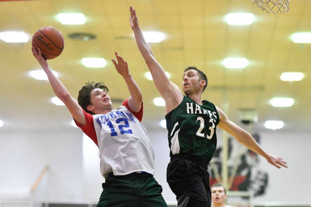 Klukwans Guy Bean, left, shoots against Haines Ryan Olsen in a B bracket game at the Juneau Lions Club 73rd Annual Gold Medal Basketball Tournament at Juneau-Douglas High School: Yadaa.at Kalé on Tuesday, March 19, 2019. Haines won 97-51. (Michael Penn | Juneau Empire)