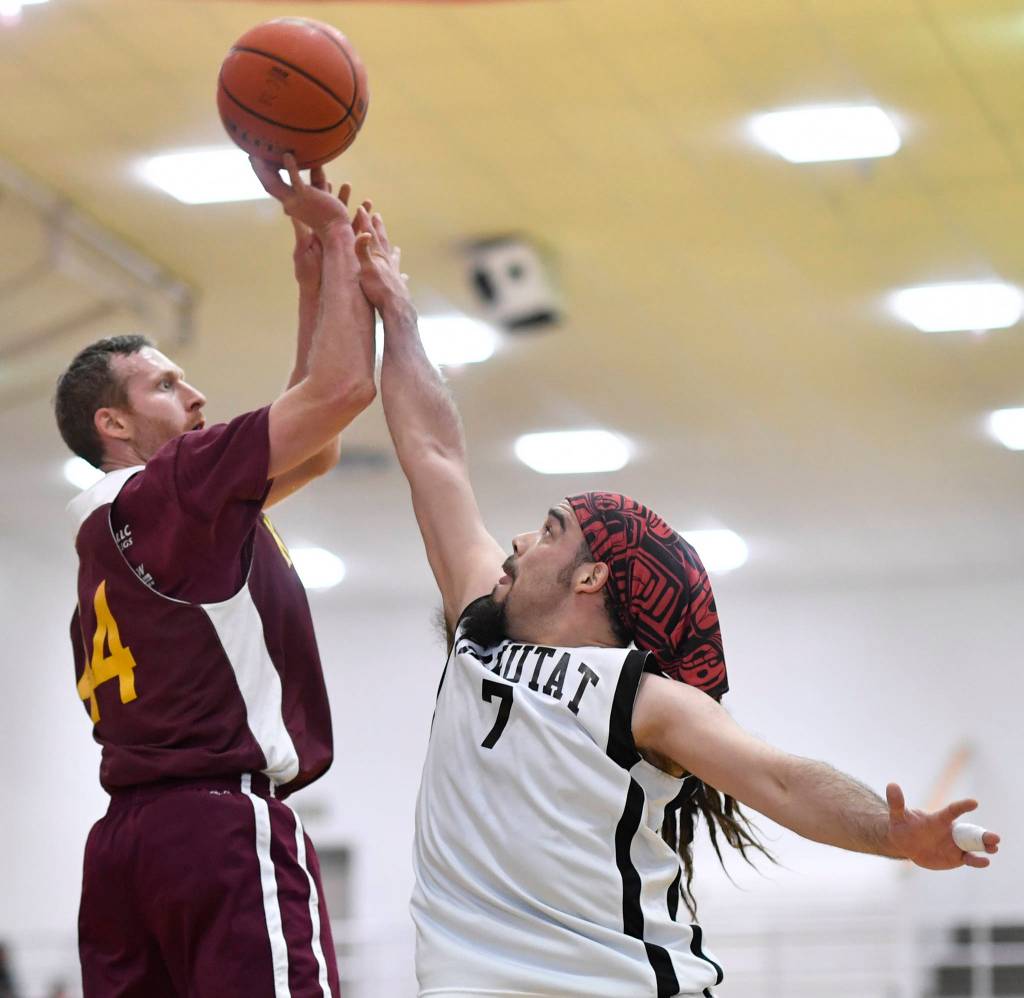 Klukwans Andrew Friske, left, shoots against Yakutats JP Buller at the Juneau Lions Club 73rd Annual Gold Medal Basketball Tournament at Juneau-Douglas High School: Yadaa.at Kalé on Tuesday, March 19, 2019. Klukwan won 94-61. (Michael Penn | Juneau Empire)