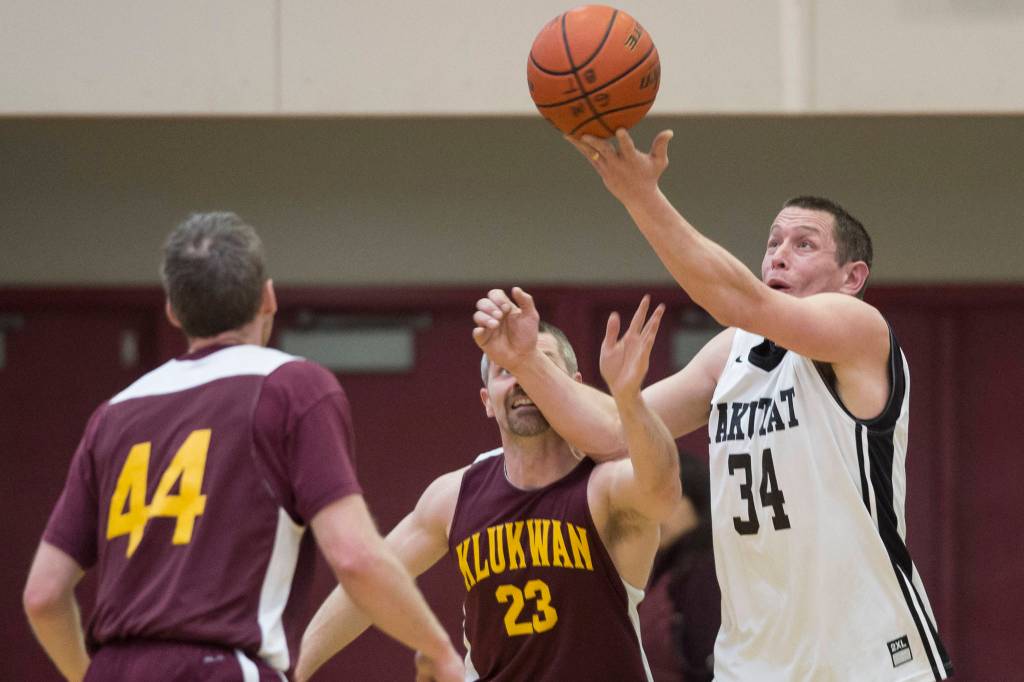Yakutats Jimmi Jensen, right, rebounds the ball over Klukwans Michael Ganey at the Juneau Lions Club 73rd Annual Gold Medal Basketball Tournament at Juneau-Douglas High School: Yadaa.at Kalé on Tuesday, March 19, 2019. Klukwan won 94-61. (Michael Penn | Juneau Empire)