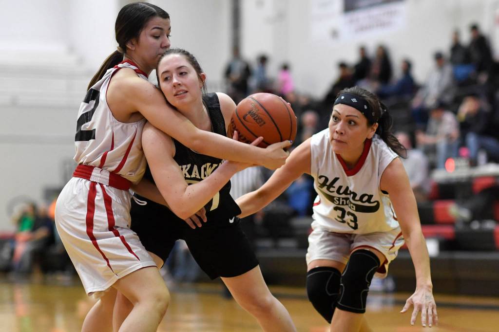 Skagways Hailey Jensen, center, is closely guarded by Hoonahs Ronnie Roberts, left, and Krissy Benn at the Juneau Lions Club 73rd Annual Gold Medal Basketball Tournament at Juneau-Douglas High School: Yadaa.at Kalé on Tuesday, March 19, 2019. Skagway won 80-42. (Michael Penn | Juneau Empire)