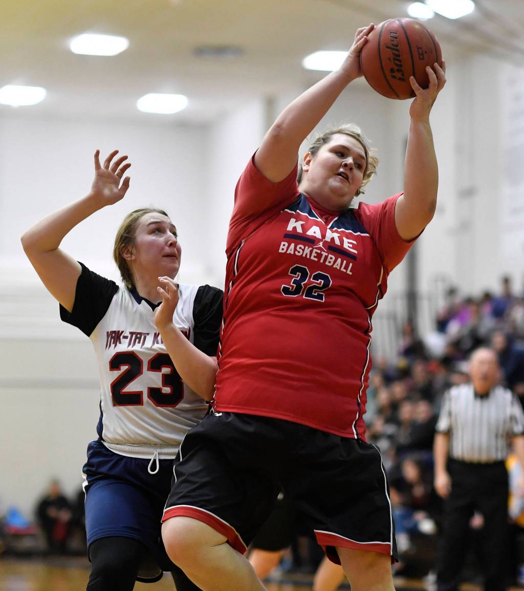 Kakes Paulette Aceveda, right, rebounds against Yakutats Janie Jensen at the Juneau Lions Club 73rd Annual Gold Medal Basketball Tournament at Juneau-Douglas High School: Yadaa.at Kalé on Tuesday, March 19, 2019. Yakutat won 64-48. (Michael Penn | Juneau Empire)