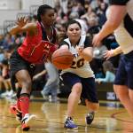 Yakutats Rose Fraker, right, passes away from Kakes Latasha Howard at the Juneau Lions Club 73rd Annual Gold Medal Basketball Tournament at Juneau-Douglas High School: Yadaa.at Kalé on Tuesday, March 19, 2019. Yakutat won 64-48. (Michael Penn | Juneau Empire)