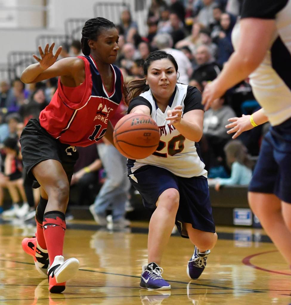 Yakutats Rose Fraker, right, passes away from Kakes Latasha Howard at the Juneau Lions Club 73rd Annual Gold Medal Basketball Tournament at Juneau-Douglas High School: Yadaa.at Kalé on Tuesday, March 19, 2019. Yakutat won 64-48. (Michael Penn | Juneau Empire)