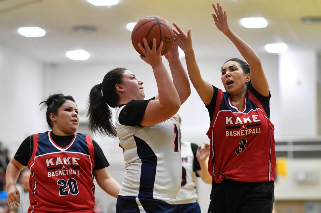 Yakutats Nadine Fraker, center, drives between Kakes Monica Ashenfelter, left, and Monica Ybarra at the Juneau Lions Club 73rd Annual Gold Medal Basketball Tournament at Juneau-Douglas High School: Yadaa.at Kalé on Tuesday, March 19, 2019. Yakutat won 64-48. (Michael Penn | Juneau Empire)
