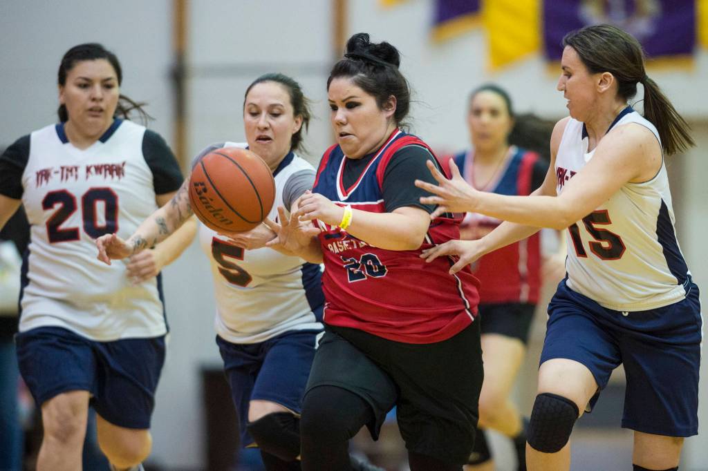 Kakes Monica Ashenfelter, is chased by Yakutats Kim Buller, left, and Lorena Williams, right, at the Juneau Lions Club 73rd Annual Gold Medal Basketball Tournament at Juneau-Douglas High School: Yadaa.at Kalé on Tuesday, March 19, 2019. Yakutat won 64-48.(Michael Penn | Juneau Empire)