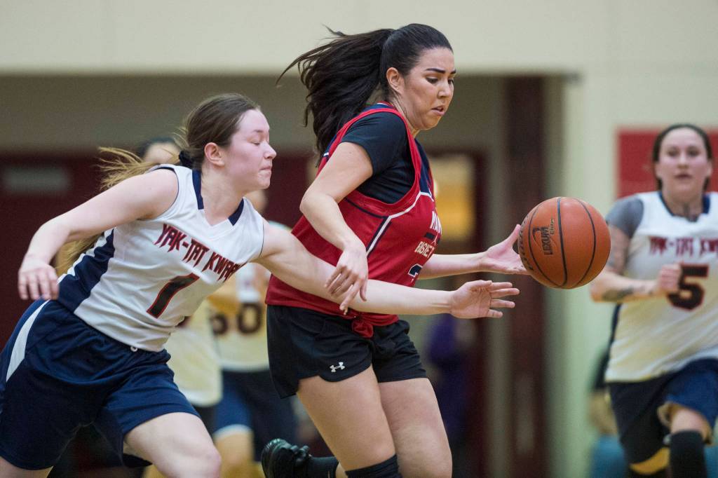 Yakutats Shaye Jensen, left, attempts a steal against Kakes Monica Ybarra at the Juneau Lions Club 73rd Annual Gold Medal Basketball Tournament at Juneau-Douglas High School: Yadaa.at Kalé on Tuesday, March 19, 2019. Yakutat won 64-48. (Michael Penn | Juneau Empire)
