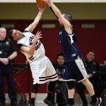 Hoonahs Albert Hinchman, left, heaves the ball against Angoons Jay Booth in a masters bracket game at the Juneau Lions Club 73rd Annual Gold Medal Basketball Tournament at Juneau-Douglas High School: Yadaa.at Kalé on Wednesday, March 20, 2019. Hoonah won 75-44. (Michael Penn | Juneau Empire)