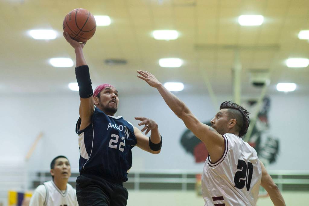 Angoons Jeff Duncan, left, shoots against Hoonahs Marti Fred in a masters bracket game at the Juneau Lions Club 73rd Annual Gold Medal Basketball Tournament at Juneau-Douglas High School: Yadaa.at Kalé on Wednesday, March 20, 2019. Hoonah won 75-44. (Michael Penn | Juneau Empire)