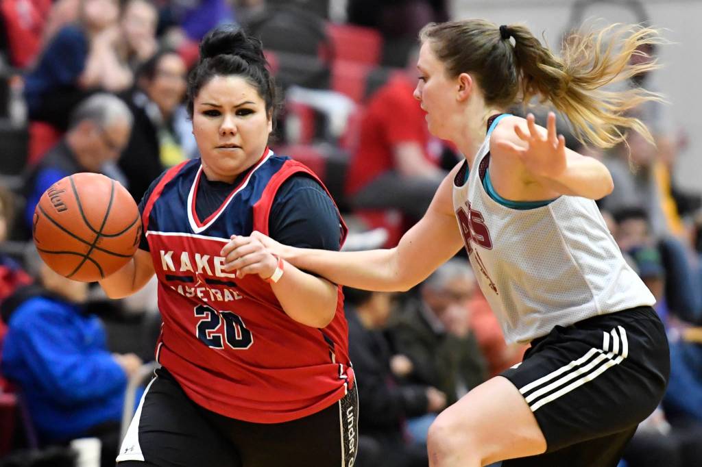 Kakes Monica Ashenfelter, left, drives against Haines Rachel Brittenham at the Juneau Lions Club 73rd Annual Gold Medal Basketball Tournament at Juneau-Douglas High School: Yadaa.at Kalé on Wednesday, March 20, 2019. Haines won 67-20. (Michael Penn | Juneau Empire)