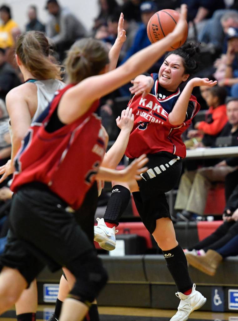 Kakes Louise Kadake, right, passes up pressure by Haines at the Juneau Lions Club 73rd Annual Gold Medal Basketball Tournament at Juneau-Douglas High School: Yadaa.at Kalé on Wednesday, March 20, 2019. Haines won 67-20. (Michael Penn | Juneau Empire)