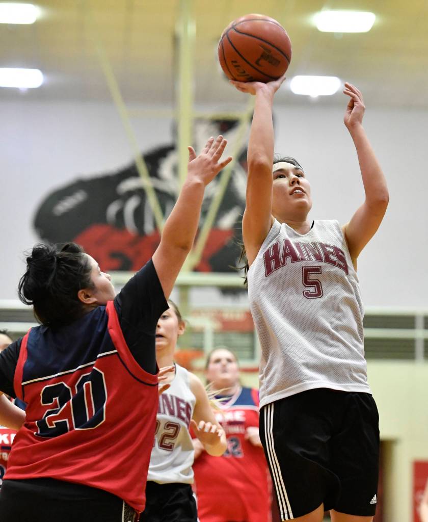 Haines Fran Daly, right, shoots against Kakes Monica Ashenfelter at the Juneau Lions Club 73rd Annual Gold Medal Basketball Tournament at Juneau-Douglas High School: Yadaa.at Kalé on Wednesday, March 20, 2019. Haines won 67-20. (Michael Penn | Juneau Empire)