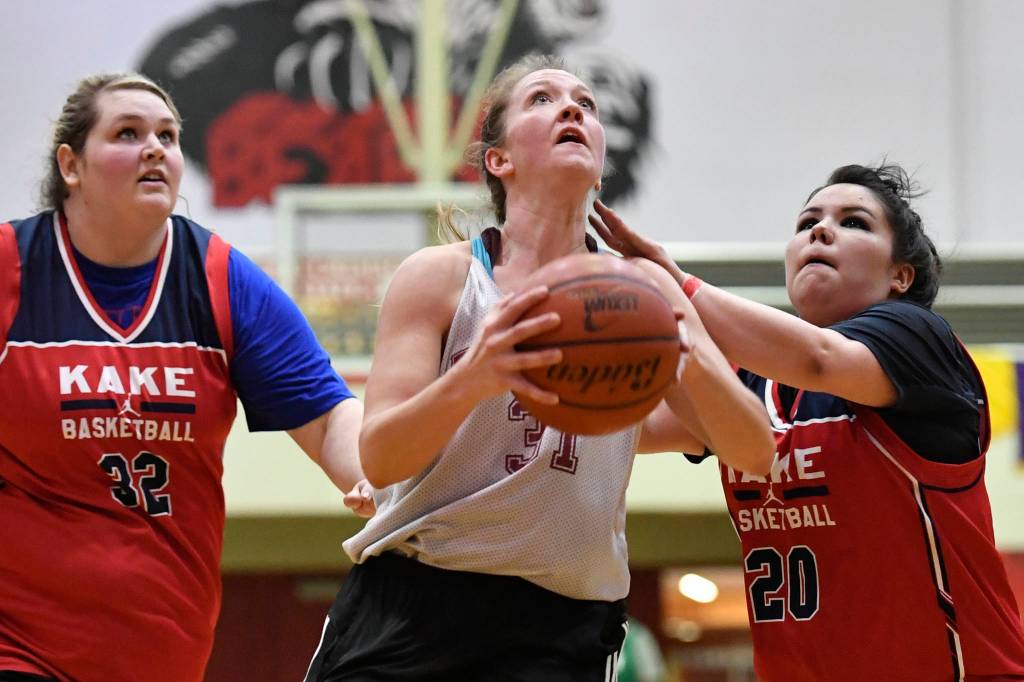 Haines Rachel Brittenham drives to the basket against Kakes Monica Ashenfelter, left, and Hannah Ashenfelter at the Juneau Lions Club 73rd Annual Gold Medal Basketball Tournament at Juneau-Douglas High School: Yadaa.at Kalé on Wednesday, March 20, 2019. Haines won 67-20. (Michael Penn | Juneau Empire)