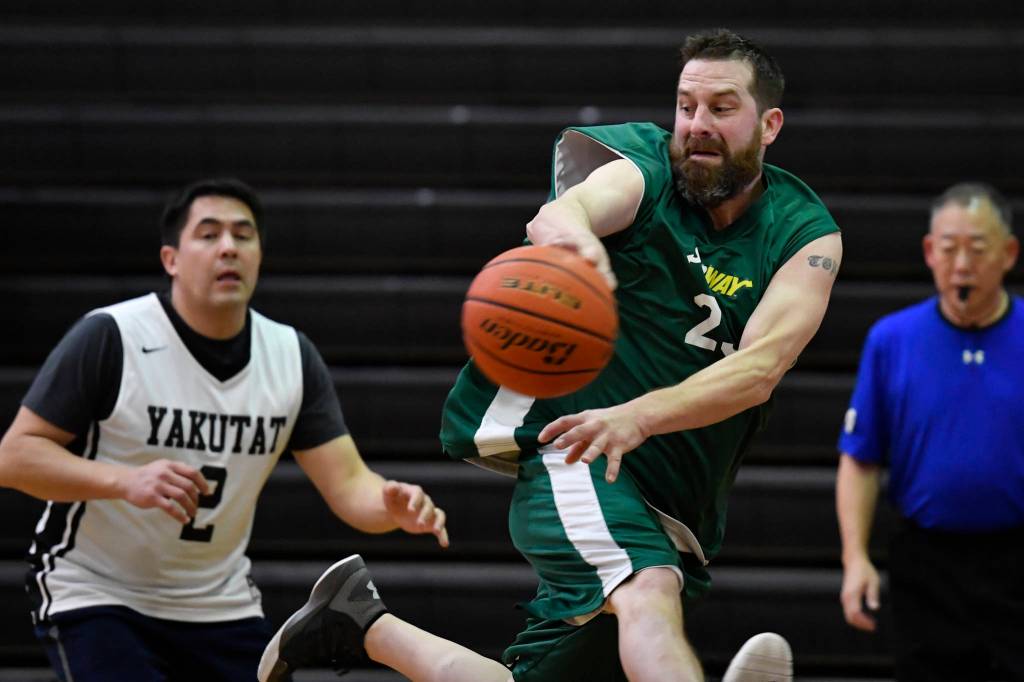 Sitkas Terry Elixman makes a save in front of Yakutats Anthony Mallott in a masters bracket game at the masters bracket game at the Juneau Lions Club 73rd Annual Gold Medal Basketball Tournament at Juneau-Douglas High School: Yadaa.at Kalé on Wednesday, March 20, 2019. Yakutat won 66-49. (Michael Penn | Juneau Empire)