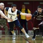 Yakutats Anthony Mallott, center, dribbles away from Hoonahs Ed Mercer, left, and Kamal Lindoff in the Masters bracket game at the Gold Medal Basketball Tournament on Thursday, March 21, 2019. (Michael Penn | Juneau Empire)
