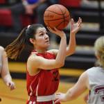 Hoonahs Ronnie Roberts shoots between Haines Sam Clay, left, and Sabrina Stickler in their womens bracket game at the Gold Medal Basketball Tournament on Thursday, March 21, 2019. (Michael Penn | Juneau Empire)
