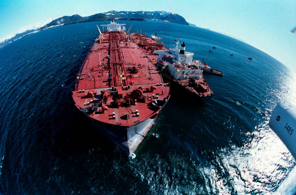 In this April 4, 1989 photo, the grounded tanker Exxon Valdez, left, unloads oil onto a smaller tanker, San Francisco, as efforts to refloat the ship continue on Prince William Sound. The Exxon Valdez tanker struck Alaskas Bligh Reef on March 24, 1989, while bound for California. It spilled about 11 million gallons of crude oil, which storms and currents smeared across about 1,300 miles of shoreline. (Rob Stapleton | Associated Press File)
