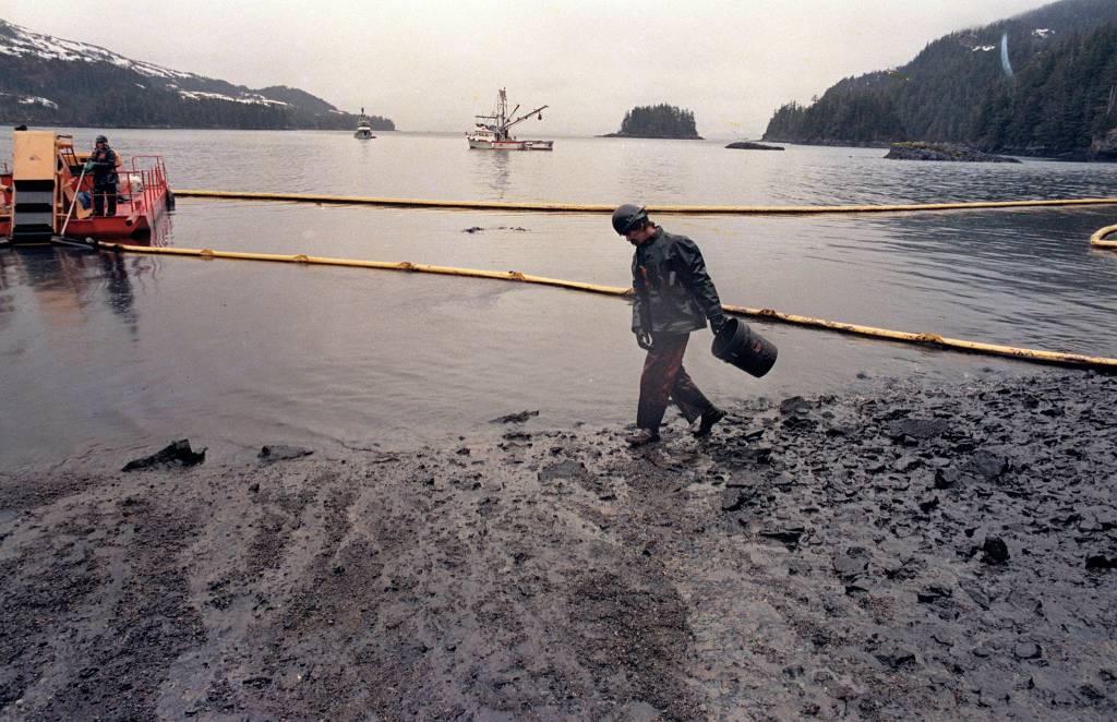 In this April 17, 1989 photo, a worker makes his way across the polluted shore of Block Island, Alaska, as efforts are underway to test techniques to clean up the oil spill of the tanker Exxon Valdez in Prince William Sound. The Exxon Valdez tanker struck Alaskas Bligh Reef on March 24, 1989, while bound for California. It spilled about 11 million gallons of crude oil, which storms and currents smeared across about 1,300 miles of shoreline. (John Gaps III | Associated Press File)