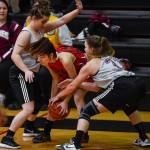 Hoonahs Ronie Roberts is trapped by Haines Sam Clay, left, and Rachel Brittenham in the womens bracket game at the Gold Medal Basketball Tournament on Thursday, March 21, 2019. (Michael Penn | Juneau Empire)