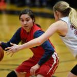Hoonahs Melissa Fisher dribbles under pressure by Haines Liz Segars in the womens bracket game at the Gold Medal Basketball Tournament on Thursday, March 21, 2019. (Michael Penn | Juneau Empire)