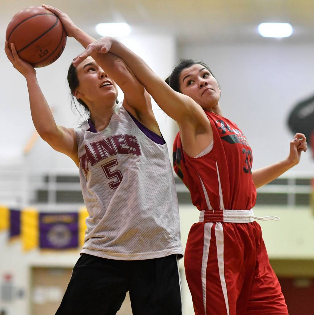 Hoonahs Ronie Roberts, right, attempts to block Haines Fran Daly in the womens bracket game at the Gold Medal Basketball Tournament on Thursday, March 21, 2019. (Michael Penn | Juneau Empire)