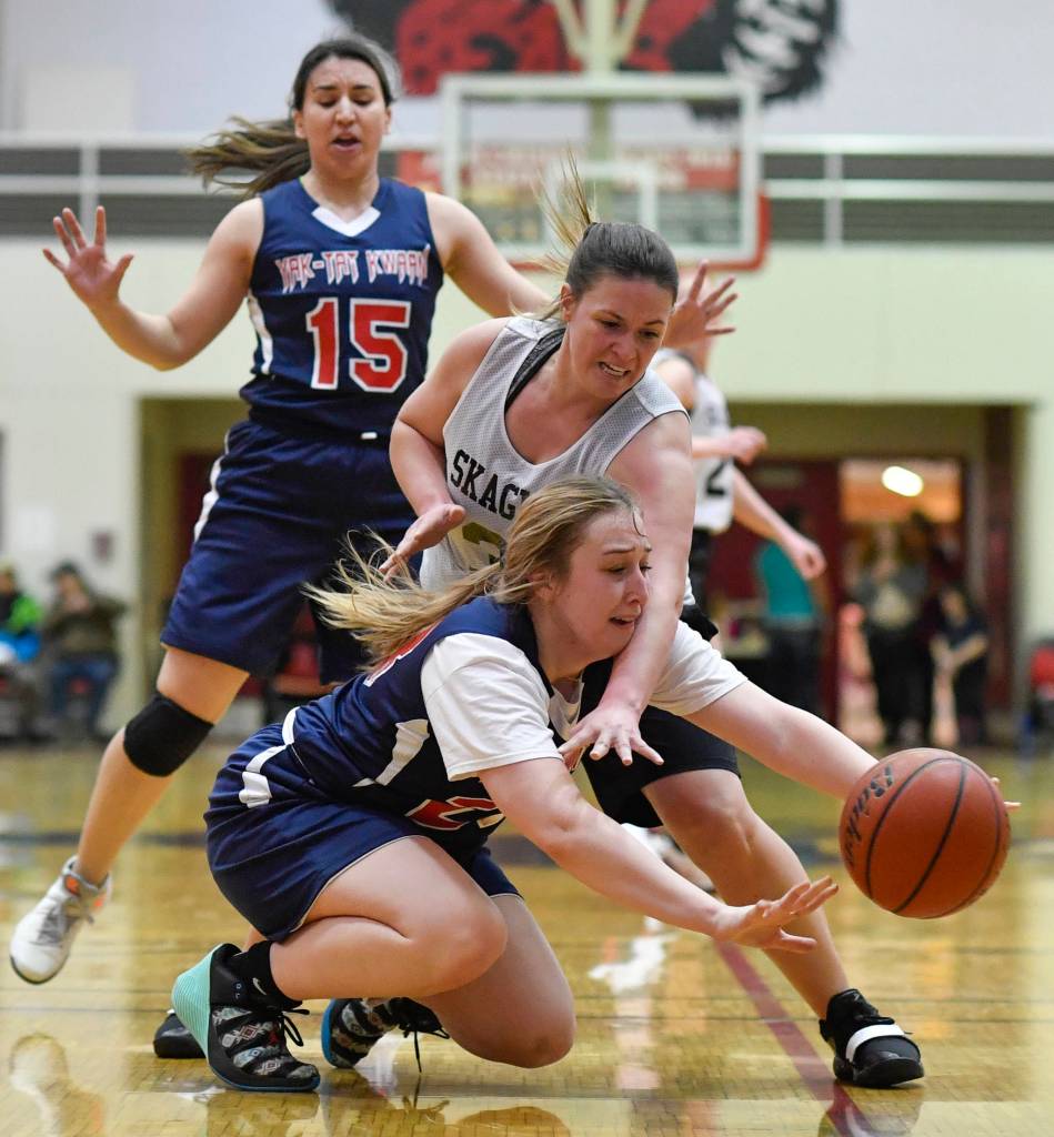 Yakutats Janie Jensen, below, and Skagways Tiffanie Ames dive for a loose ball during the womens bracket game at the Gold Medal Basketball Tournament on Thursday, March 21, 2019. (Michael Penn | Juneau Empire)