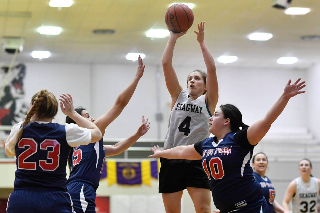 Skagways Kailyn Jerod shoots over Yakutats Cheyenne Ekis, left, Lorena Williams, center, and Nadine Fraker during the womens bracket game at the Gold Medal Basketball Tournament on Thursday, March 21, 2019. (Michael Penn | Juneau Empire)