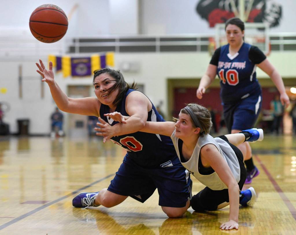 Yakutats Rose Fraker, left, and Skagways Kaylei Smith dive for a loose ball during the womens bracket game at the Gold Medal Basketball Tournament on Thursday, March 21, 2019. (Michael Penn | Juneau Empire)