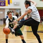 Metlakatlas Shane Martinez, right, gets a foot on the ball against Haines Orion Farley during their B bracket game at the Juneau Lions Club 73rd Annual Gold Medal Basketball Tournament at Juneau-Douglas High School on Friday, March 22, 2019. (Michael Penn | Juneau Empire)