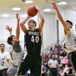 Haines Dylon Swinton, shoots against Metlakatlas Tadd Yleniemni, left, and Zavier Ghormely in their B bracket game at the Juneau Lions Club 73rd Annual Gold Medal Basketball Tournament at Juneau-Douglas High School on Friday, March 22, 2019. (Michael Penn | Juneau Empire)
