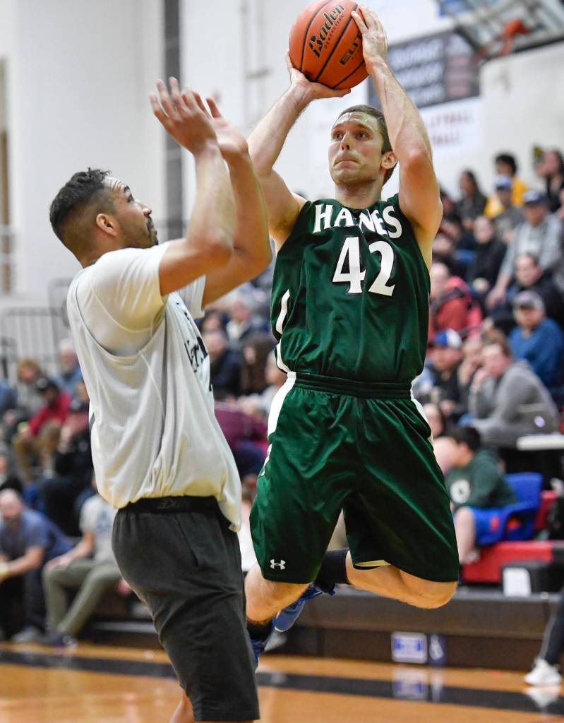 Haines Kyle Fossman, right, shoot against Metlakatlas Chris Bryant in their B bracket game at the Juneau Lions Club 73rd Annual Gold Medal Basketball Tournament at Juneau-Douglas High School on Friday, March 22, 2019. (Michael Penn | Juneau Empire)