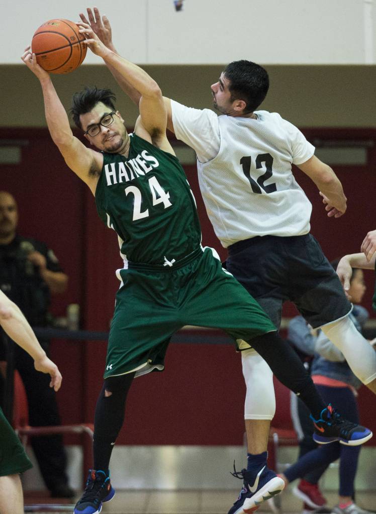 Haines James Hart rebounds against Metlakatlas Franklin Hayward in their B bracket game at the Juneau Lions Club 73rd Annual Gold Medal Basketball Tournament at Juneau-Douglas High School on Friday, March 22, 2019. (Michael Penn | Juneau Empire)